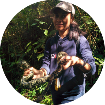 Photo of Hasinavalona Rakotoarisoa holding a snake in Madagascar.